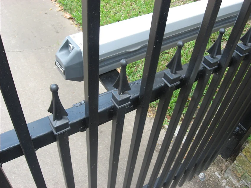 Automatic gate operator installed on ornamental fence