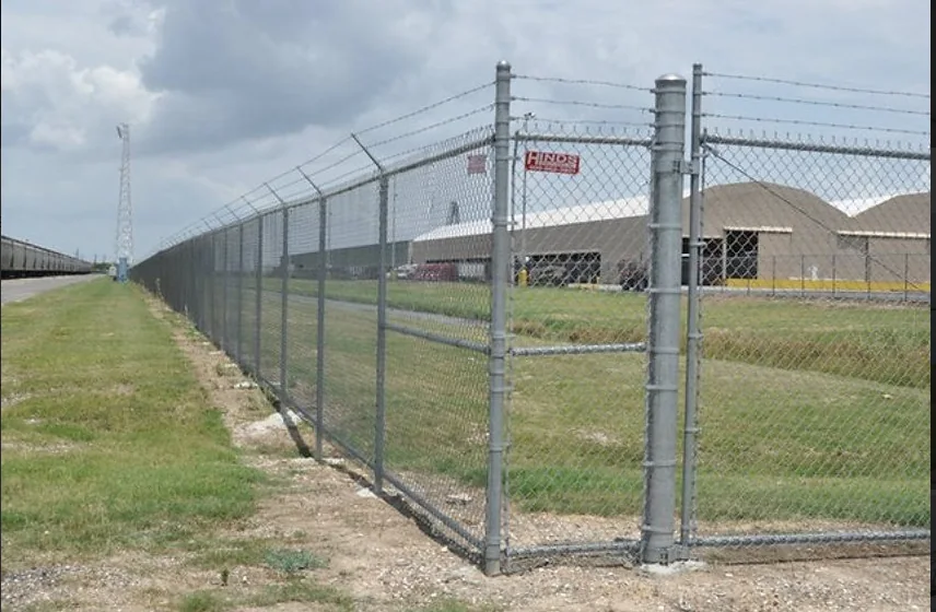 Industrial chain link perimeter fence at a large facility