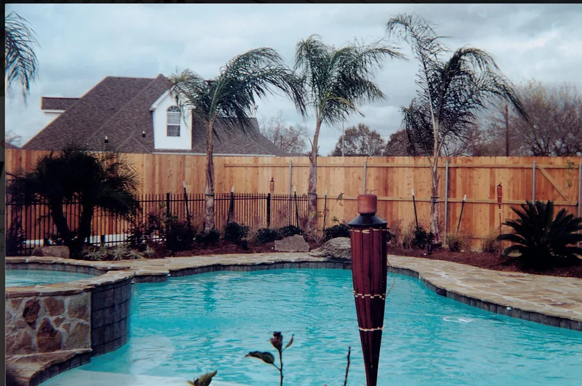 Pool area enclosed by wood fencing