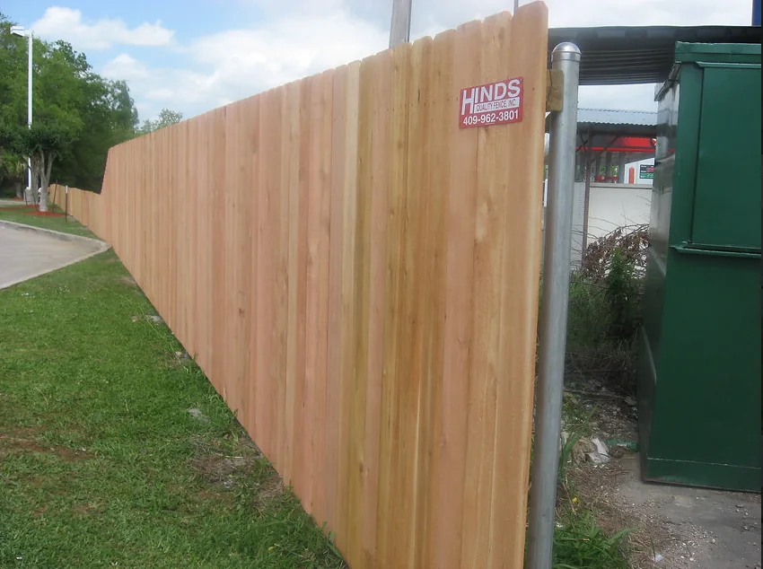 Long wood privacy fence installed along a property
